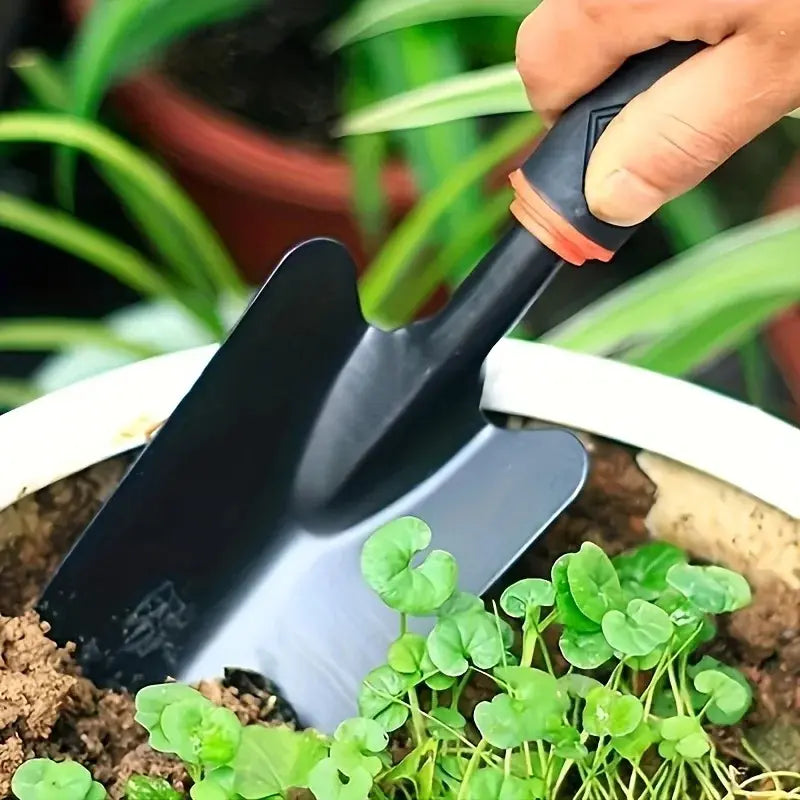 A Set of Four Outdoor Gardening Tools Including a Small Shovel for Planting Flowers, a Five-Pronged Rake, a Double-Headed Rake, Metal Tool Kit