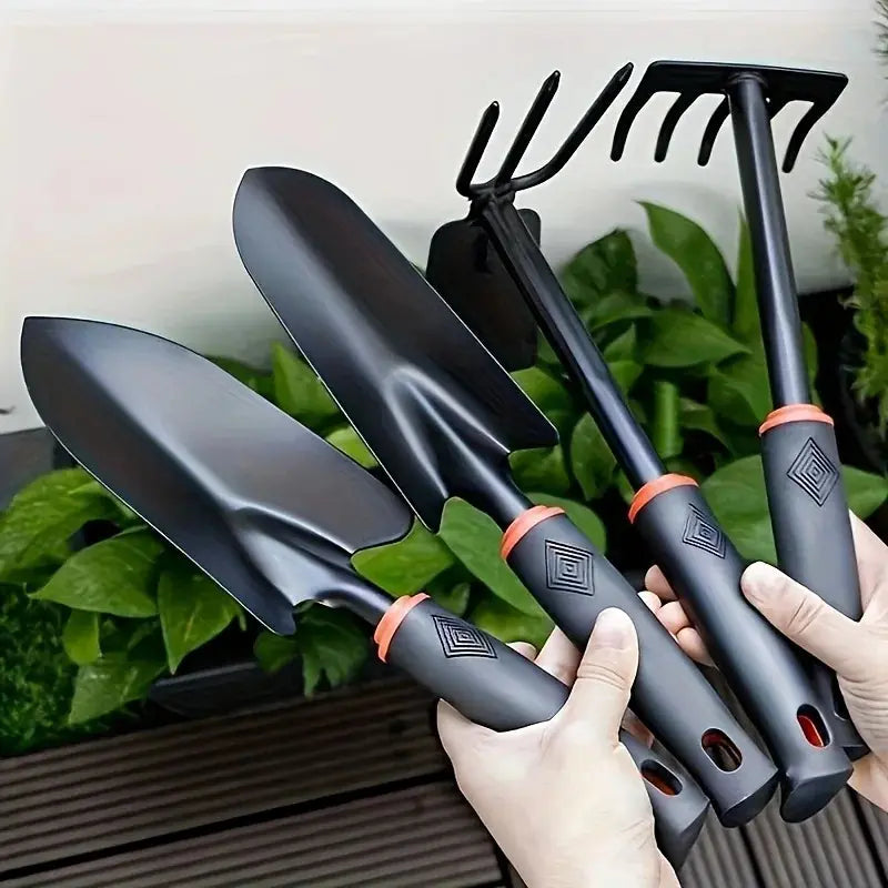 A Set of Four Outdoor Gardening Tools Including a Small Shovel for Planting Flowers, a Five-Pronged Rake, a Double-Headed Rake, Metal Tool Kit